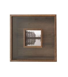 a wooden frame with a reflection of trees in it