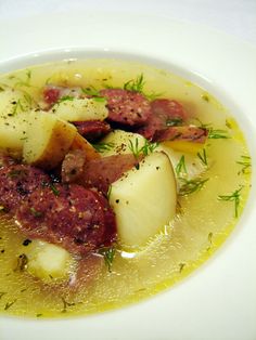 a white plate topped with potatoes and meat