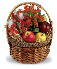 a basket filled with lots of fruit and flowers