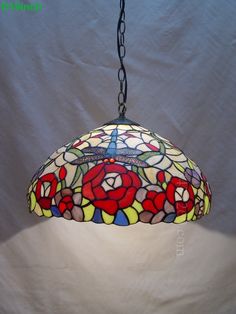 a stained glass lamp hanging from a chain