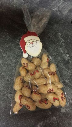 a plastic bag filled with peanuts and santa clause hat on top of a granite counter