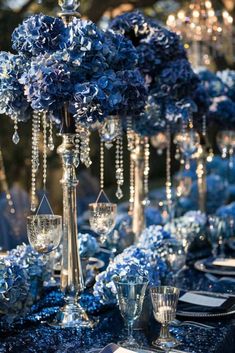 the table is set with blue flowers and crystal candlesticks for an elegant touch