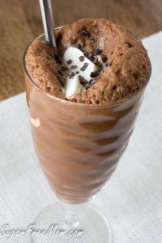 a chocolate milkshake with whipped cream and chocolate chips