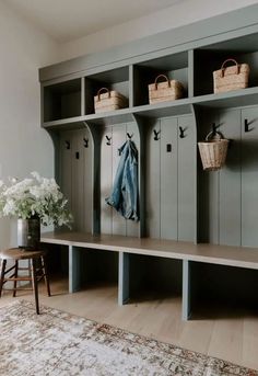 a room filled with lots of gray lockers and baskets on top of each shelf