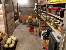 a room filled with lots of different types of vegetables and fruit on shelves next to each other