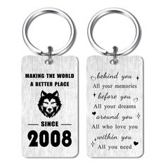 two key chains with the words making the world a better place and an image of a wolf