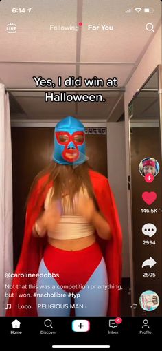 a woman in a red cape and blue mask standing in front of a mirror with the caption'yes, i did win at halloween '