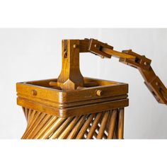 a close up of a wooden basket on a white background with the handle extended out