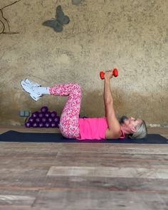 a woman is doing an exercise with dumbbells