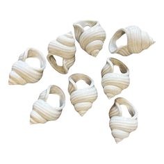 six pieces of white ceramic art work on a white background