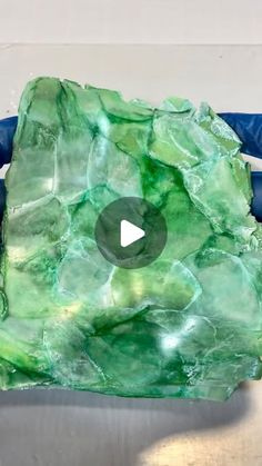 a piece of green rock sitting on top of a table