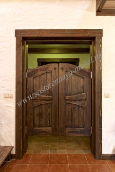 an open wooden door in a white wall