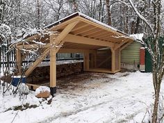 a covered area in the woods with snow on the ground