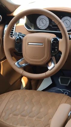 the interior of a car with brown leather seats and gauges on it's dashboard