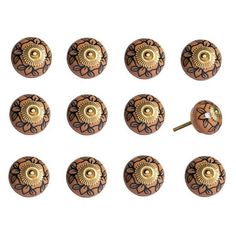 twelve brown and gold knobs with an intricate design on the front, back and sides