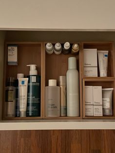 a wooden shelf filled with lots of different types of skin care products