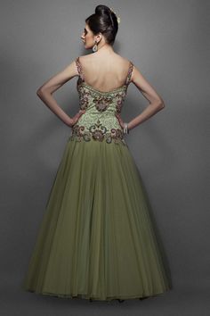 This dusky green color Indo western bridal gown has pink & green resham work, with silver & gold zircons and silver swirls in the centre. The form is fitted through the body with a soft voluminous net & dupion silk flair. Green Floor-length Evening Dress With Fitted Bodice, Green Fitted Bodice Floor-length Evening Dress, Green Sweetheart Neckline Ball Gown For Party, Green Organza Lehenga For Wedding, Green Evening Dress With Fitted Bodice And Sweetheart Neckline, Green Gown With Sweep Train And Fitted Bodice, Green Bollywood Style Dress For Reception, Green Organza Dress For Reception, Green Bollywood Dress For Reception