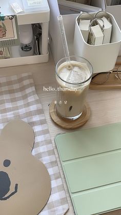 there is a bear shaped coaster next to a cup of coffee on the counter top