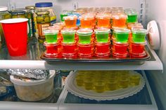 a refrigerator filled with lots of different colored drinks