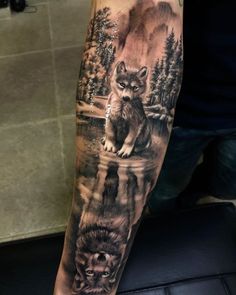 a man's arm with an animal tattoo on it, and the image of two wolf