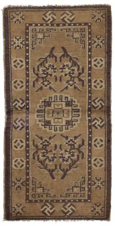 an old rug with brown and tan colors