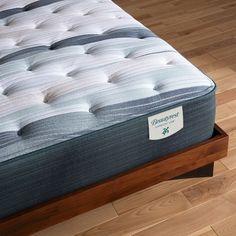 an image of a mattress that is on the bed frame in the room with wood flooring