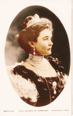 an old black and white photo of a woman wearing a tiara