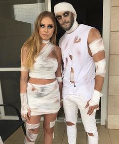 a man and woman dressed up in white outfits with bandages on their arms, legs and ankles