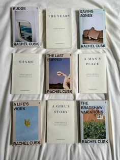 eight books are laid out on a white sheet in order to be read by the reader