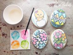 four decorated cookies sitting on top of a table