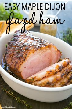 a close up of a meat in a bowl with text overlay that reads easy maple dijon gaged ham