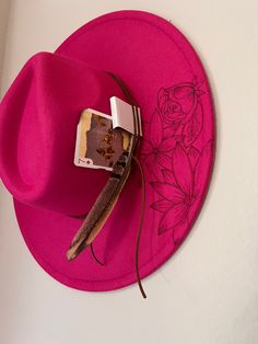 Be the life of the rodeo in this gorgeous boho red hat featuring a bull, poppies, and playful longhorns. Add this accessory to your wardrobe for a unique western touch. Red Western Fedora For Kentucky Derby, Red Western Hat For Fall, Adjustable Red Hat Bands For Spring, Red Western Felt Hat For Festival, Red Hat For Rodeo Spring Season, Red Hats For Rodeo Spring Season, Red Hats For Rodeo In Spring, Red Spring Rodeo Hat, Trendy Hats For Kentucky Derby Festival