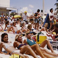 a group of people laying on top of a sandy beach