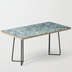 a table with blue and white speckles on it, in front of a white background