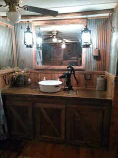 a bathroom with a sink, mirror and lights