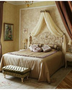 a bedroom with a canopy bed and white curtains