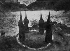 an old black and white photo of trees in the water