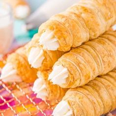 some croissants are stacked on top of each other with icing in them