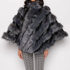 The Runway Supermodel Status Moto Poncho With Faux Fur Is A Faux Fur And Faux Leather Panel Style Poncho Complete With An Asymmetrically Draped Design, A High Neckline, And A Front Zipper Closure. Pair With Knit Midi Dresses And Knee High Boots For A Cozy Chic Look. - 90% Acrylic 10% Polyester - Dry Clean Only Cape Outerwear With Faux Fur Trim For Cold Weather, Elegant Cape Fur Coat With Faux Fur Trim, Elegant Faux Fur Cape Outerwear, Luxury Faux Fur Cape For Winter, Winter Faux Fur Poncho With Trim, Neutral Jacket, Fringe Coats, Plaid Capes, Vintage Fur Stole