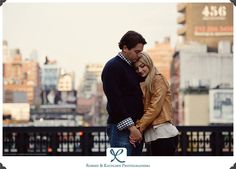 a man and woman standing next to each other in front of a cityscape