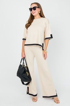 This chic set features a neutral beige sweater knit with a black trim. Mix-and-match the pieces, or wear them together! Set includes matching top and pants. also offered in black DETAILS Top: Slit detail on sleeves and sides Relaxed fit Bust measures approximately: S - 40" M - 42" L - 44" *Bust measurements are taken when a garment is laid flat Pants: Slit detail on... Off Shoulder Jacket, Flat Pants, Blue Door, Comfy Tops, Neutral Beige, Beige Sweater, Sweater Set, Matching Top, Sweater Knit