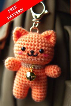 a crocheted teddy bear keychain hanging from a car seat