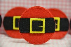 closeup of santa claus's belt on red and black fabric with yellow letters