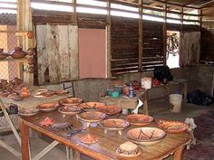 a table with many bowls on it in a room that is being used as a workshop