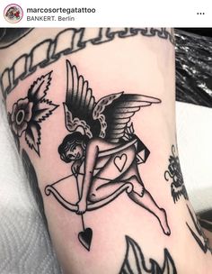 a woman with an arrow and heart tattoo on her leg