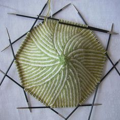 an arrangement of needles are arranged in the shape of a flower