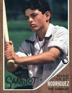 a young man holding a baseball bat on top of a wooden plaque with the name sandlot