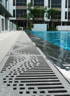 an empty swimming pool in front of a building