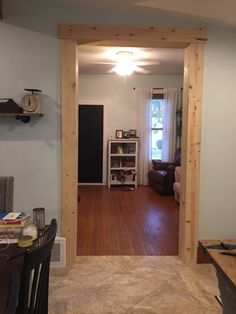 an open door leading to a living room and dining room