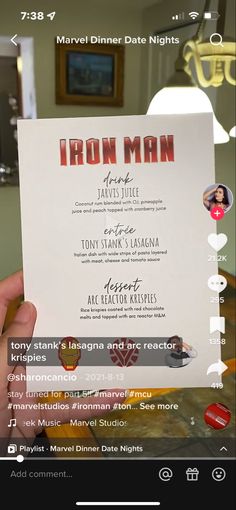 a person holding up a menu for iron man